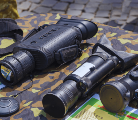 Thermal imaging optics and night vision optics are placed on a camouflaged surface